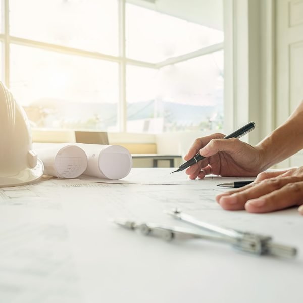 Hands of Engineer working on blueprint,Construction concept. Engineering tools.Vintage tone retro filter effect,soft focus(selective focus)